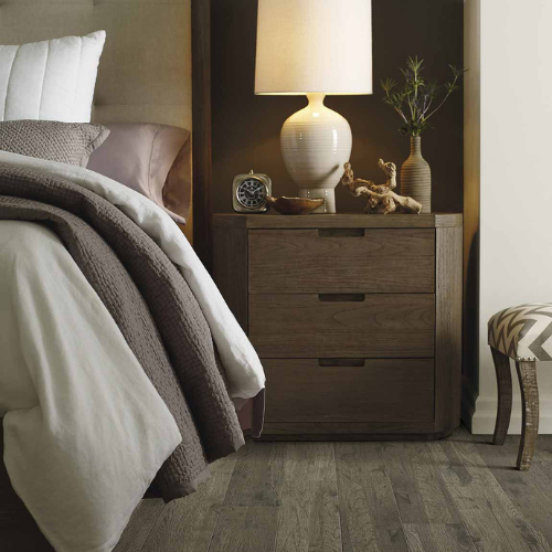 laminate in a bedroom, wood-look side table, brown bedding